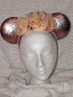 These ears are made with rose gold sequin fabric.  They're trimmed with pale pink gemstones.  The flowers are pale pink with a slight peach undertone.  The headband is pink satin.  These ears are slightly upscale from traditional ears and would look lovely with all the dresses that are becoming more popular to wear at the parks. Gold Sequin Fabric, Minnie Ears Headband, Rose Gold Sequin, Star Wars Inspired, Ears Headband, Minnie Ears, Costume Hats, Pink Gemstones, Gold Sequins