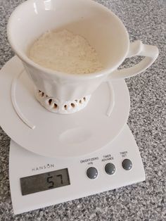 a white coffee cup on top of a scale