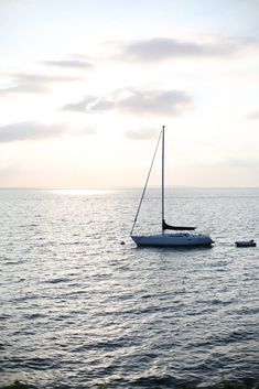 a sailboat floating on top of the ocean