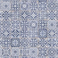 a blue and white tiled wall with different designs