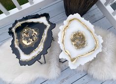 two black and white trays with gold designs on them