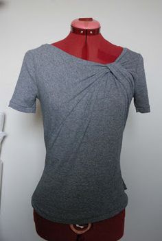 a woman's gray top with a red neckline on a mannequin