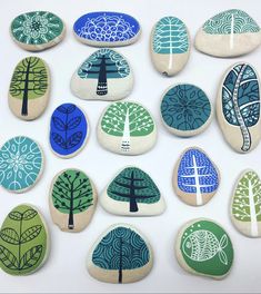 a group of painted rocks with trees on them