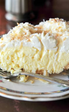 a piece of coconut cream pie on a plate with a fork