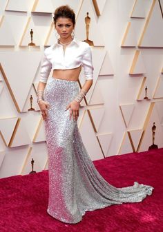 an image of a woman on the oscars red carpet wearing a silver skirt and crop top