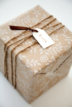 three wrapped gift boxes with tags on them