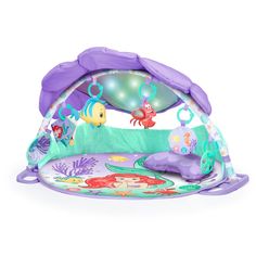 an infant's play gym mat with mermaids and fish on it, in purple