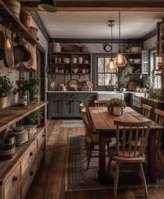 a wooden table sitting in the middle of a kitchen filled with lots of pots and pans