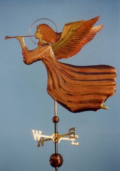 a weather vane with an angel playing the trumpet