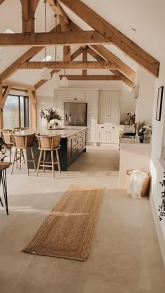 an open floor plan with white walls and wood beams