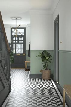 an entryway with black and white checkered flooring, potted plant on the far side