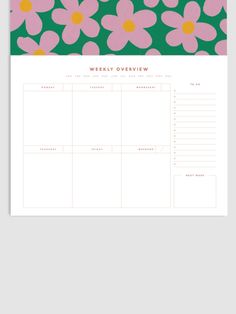 the weekly planner with pink and yellow flowers on green, is shown in front of a gray background