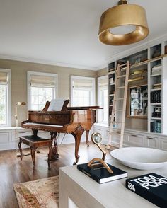 a living room filled with furniture and a grand piano