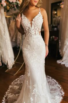 a woman in a wedding dress posing for the camera