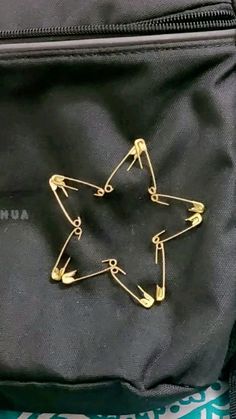 a star pin sitting on top of a black bag