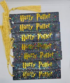 harry potter's wands are on display in front of a white wall with yellow writing