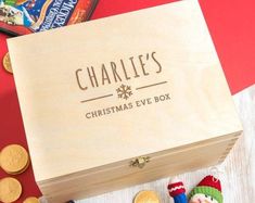 personalised wooden christmas eve box with toys and money on the table next to it