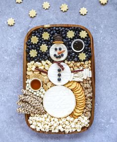 an image of a snowman made out of cookies and crackers on a tray