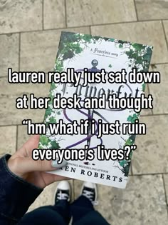 someone holding up a book with the words lauren really just sat down at her desk and thought