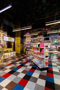 an empty store with checkered flooring and neon lights