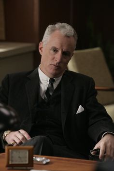 a man in a suit sitting at a table