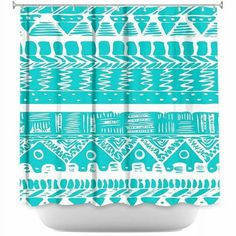 a blue and white shower curtain with an abstract design on the front, in shades of turquoise