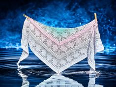 a white shawl is hanging over the water