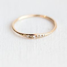 a gold ring with three diamonds on it