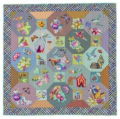 a quilted wall hanging with many different types of flowers and animals on it's sides