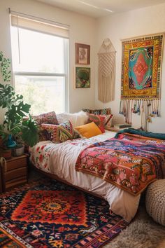 a bedroom with a bed, rugs and pictures on the wall