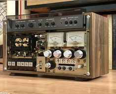 an old radio sitting on top of a wooden table