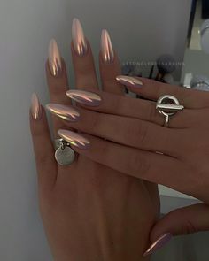 a woman's hand with shiny nails and rings