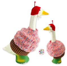 two stuffed birds wearing knitted hats on top of each other