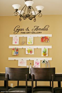 a dining room table and chairs with artwork on the wall behind it that says cogan & amplia fine art gallery