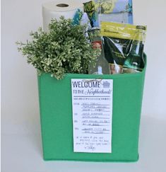 a welcome to the neighborhood sign in a green container filled with toilet paper and plants