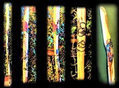 four snow skis lined up against a green wall