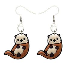 a pair of earrings with an image of a panda bear on the front and back