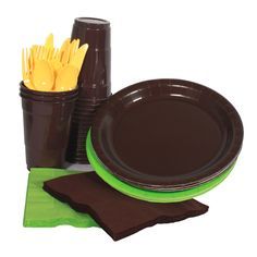 there is a brown and green table setting with plastic utensils in the cup