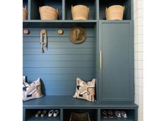 a blue bench with baskets and hats on it's back, next to some shoes