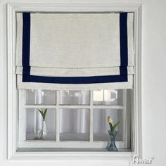 a white window with blue trim and some flowers in the vases on the windowsill