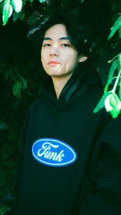 a young man wearing a black hoodie with the ford logo on it