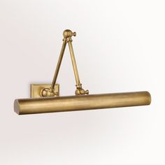 an antique brass finish wall light with two arms