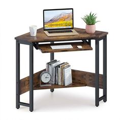 a laptop computer sitting on top of a wooden desk next to a clock and books