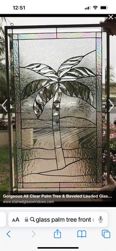 a stained glass window with a palm tree on it