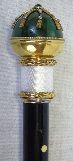 a close up of a wine bottle on a white surface with gold trimmings