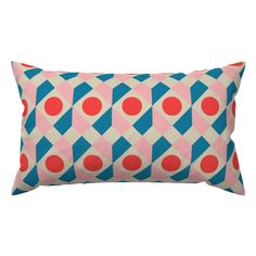 a pink and blue pillow with red dots on it