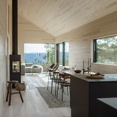 a living room filled with furniture and a fire place next to a wall mounted stove