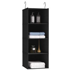 three shelves with towels and other items on top of each shelf, one is black