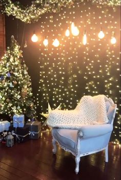 a living room decorated for christmas with lights on the wall and presents under the tree