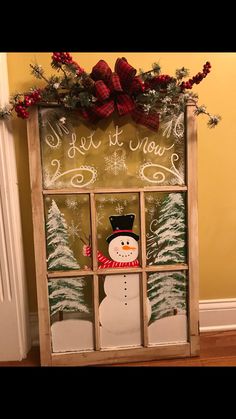 an old window decorated for christmas with a snowman